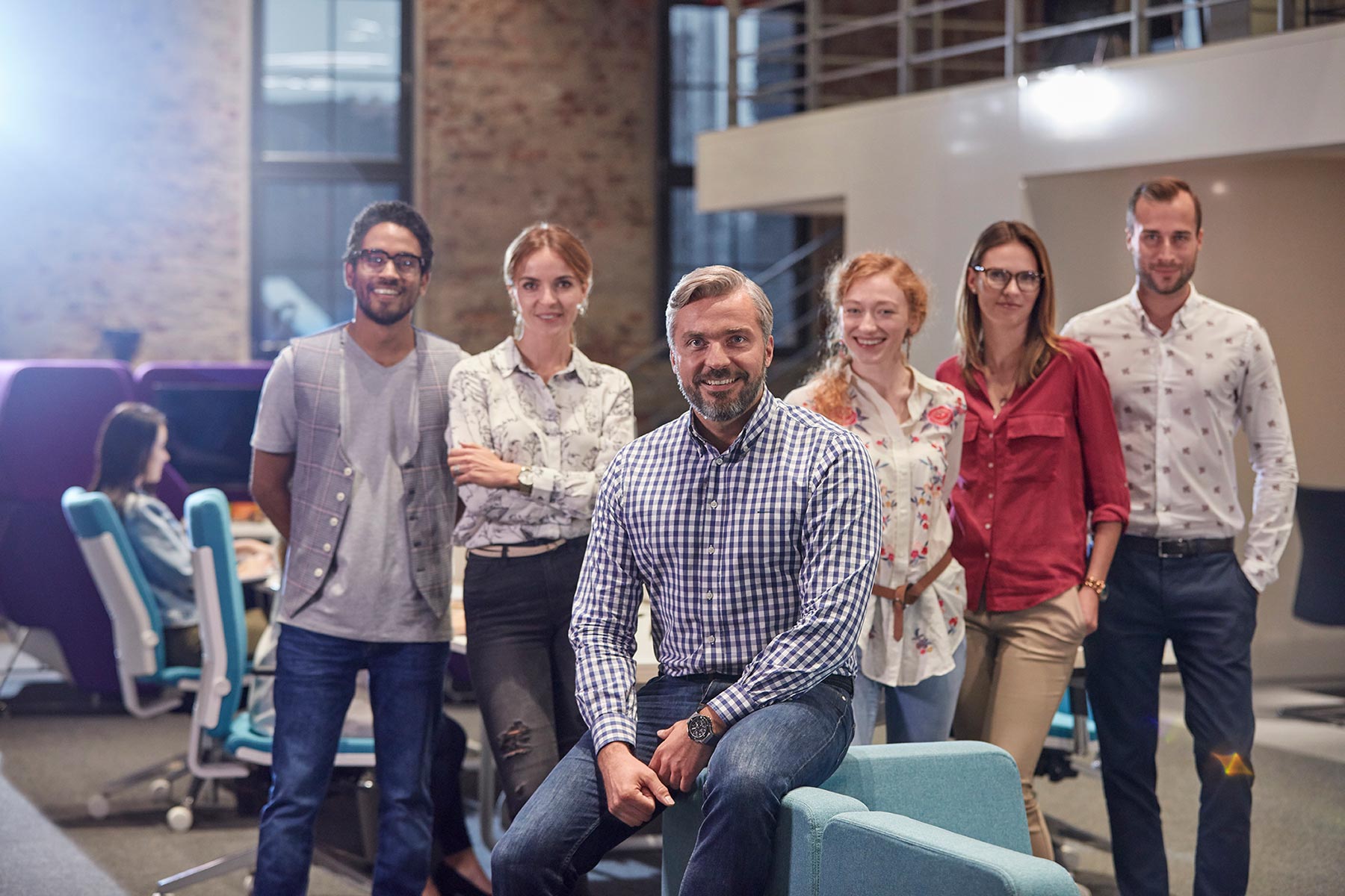 A startup team of six professionals posing confidently in a modern office, representing collaboration, strategy, and lean growth.